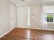 Bright foyer with hardwood flooring, a white front door, and a window allowing natural light to fill the space at 3830 Brookchase Ln, Charlotte, NC 28205