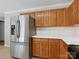 Kitchen with stainless steel refrigerator, white countertops, and wooden cabinets at 3830 Brookchase Ln, Charlotte, NC 28205