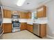 Well-lit kitchen with white countertops, tile backsplash, and stainless steel appliances at 3830 Brookchase Ln, Charlotte, NC 28205