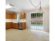 Bright kitchen with wooden cabinets, stainless steel appliances, and a sliding glass door to the backyard at 3830 Brookchase Ln, Charlotte, NC 28205