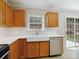 Renovated kitchen features stainless steel appliances, white tile backsplash, and a farmhouse sink at 3830 Brookchase Ln, Charlotte, NC 28205