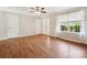 Spacious living room featuring hardwood flooring, neutral walls, and a bright window for natural light at 3830 Brookchase Ln, Charlotte, NC 28205