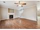 Spacious living area features hardwood floors, fireplace, neutral walls, and a view of the staircase to the upper level at 3830 Brookchase Ln, Charlotte, NC 28205