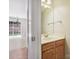 This functional powder room features a wooden vanity, a sink, and a well-lit mirror at 3830 Brookchase Ln, Charlotte, NC 28205