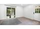 Bright bedroom with tile floors, patio access, and fresh white walls at 408 Kennerly Dr, Indian Trail, NC 28079
