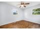 Cozy bedroom with hardwood floors, bright windows, and a ceiling fan at 408 Kennerly Dr, Indian Trail, NC 28079