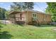 Rear exterior featuring a deck, sliding glass door, and well-maintained yard at 408 Kennerly Dr, Indian Trail, NC 28079
