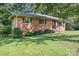Quaint brick house with a well-kept lawn, and black window shutters adding charm at 408 Kennerly Dr, Indian Trail, NC 28079