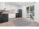 Functional kitchen with white cabinets, black appliances, and sliding glass door access at 408 Kennerly Dr, Indian Trail, NC 28079