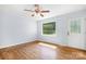 Bright living room featuring hardwood floors, a ceiling fan, and a large window at 408 Kennerly Dr, Indian Trail, NC 28079