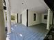 A covered porch showcasing wood flooring, classic columns, and black trim at 409 Everette St, Monroe, NC 28112