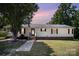 Charming single-story home with light yellow siding and classic red shutters, enhanced by mature trees and a manicured lawn at 508 Bridgestone Ln, Rock Hill, SC 29730