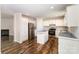 Bright kitchen featuring white cabinets, stainless steel appliances, and a functional center island on stylish laminate flooring at 508 Bridgestone Ln, Rock Hill, SC 29730