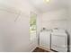 Functional laundry room features a washer, dryer, shelves, and natural light at 508 Bridgestone Ln, Rock Hill, SC 29730