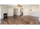 Open-concept living space with a fireplace, stylish laminate floors, and an elegant chandelier, blending comfort and sophistication at 508 Bridgestone Ln, Rock Hill, SC 29730