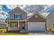 Charming two-story home showcasing a well-manicured lawn and an inviting front porch at 513 Jacobus Ln, Monroe, NC 28112