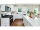 A bright kitchen with white cabinets, stainless steel appliances, and a spacious countertop at 513 Jacobus Ln, Monroe, NC 28112