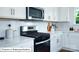 Bright kitchen featuring stainless steel appliances, white cabinetry, and stylish countertops at 513 Jacobus Ln, Monroe, NC 28112
