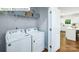 Convenient laundry area equipped with a washer, dryer, and wire shelving for storage at 513 Jacobus Ln, Monroe, NC 28112