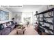 Relaxing living room featuring plush seating, a modern workspace, and a wall of stylish shelving at 513 Jacobus Ln, Monroe, NC 28112