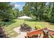 Backyard patio with outdoor seating for dining and entertaining under the shade of trees at 551 Sand Trap Dr, York, SC 29745