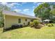 Expansive backyard with manicured lawn, patio area, and mature trees providing shade and privacy at 551 Sand Trap Dr, York, SC 29745