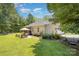 Well-maintained backyard with seating, mature trees, and manicured landscaping for outdoor enjoyment at 551 Sand Trap Dr, York, SC 29745