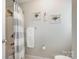 Well-lit bathroom showcasing tiled shower, framed art, and neutral decor at 551 Sand Trap Dr, York, SC 29745