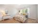 Bright bedroom features plush carpet, sunny window, and classic dresser at 551 Sand Trap Dr, York, SC 29745