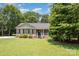 Charming brick ranch-style home with well-manicured lawn and inviting front porch at 551 Sand Trap Dr, York, SC 29745