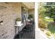 Cozy front porch featuring rocking chairs, plants, and classic brickwork at 551 Sand Trap Dr, York, SC 29745