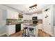 Well-lit kitchen with white cabinets, mosaic backsplash, and center island at 551 Sand Trap Dr, York, SC 29745