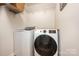 Convenient laundry area with modern washer and dryer units and storage shelves for organization at 551 Sand Trap Dr, York, SC 29745