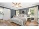 Spacious primary bedroom with wood-look flooring, crown molding, and natural light at 551 Sand Trap Dr, York, SC 29745