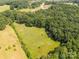 Scenic aerial image of green fields and lush forest, creating a harmonious blend of nature and tranquility at 6115 Campbell Rd, York, SC 29745