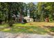 Expansive backyard with a fire pit, trampoline, playground and mature trees creating a private outdoor space at 6115 Campbell Rd, York, SC 29745