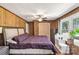 Spacious bedroom featuring wood-paneled walls, a ceiling fan, and a comfortable queen-sized bed at 6115 Campbell Rd, York, SC 29745