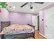 Bedroom featuring purple walls, wood-look flooring, and a comfortable bed at 6115 Campbell Rd, York, SC 29745