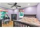 Purple bedroom featuring hardwood floors, a ceiling fan, and a comfy bed at 6115 Campbell Rd, York, SC 29745