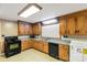 Traditional kitchen featuring wood cabinetry, laminate countertops, and a black appliance suite at 6115 Campbell Rd, York, SC 29745