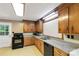 Traditional kitchen featuring wood cabinetry, laminate countertops, and a black appliance suite at 6115 Campbell Rd, York, SC 29745
