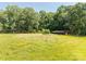 Lush green meadow with mature trees and a small shed, perfect for nature lovers and outdoor activities at 6115 Campbell Rd, York, SC 29745