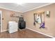 Functional laundry room with modern washer and dryer, ample storage, and laminate flooring at 6115 Campbell Rd, York, SC 29745