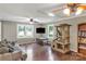 Living room with hardwood flooring, large windows, ceiling fans, and a cozy sofa at 6115 Campbell Rd, York, SC 29745