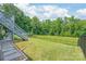Backyard with grass and fence and a stairs to an upper level at 6320 Tilley Way, Matthews, NC 28105