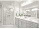 Elegant bathroom features a spacious glass enclosed shower and vanity with double sinks at 6320 Tilley Way, Matthews, NC 28105