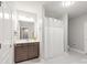 Well-lit bathroom features a shower with curtain, vanity, and white tiled floors at 6320 Tilley Way, Matthews, NC 28105