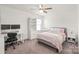 Well-lit bedroom with modern decor, a cozy bed, and dedicated desk and workspace at 6320 Tilley Way, Matthews, NC 28105