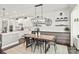 Elegant dining room with modern chandelier, custom shelving and hardwood floors creating a warm and inviting atmosphere at 6320 Tilley Way, Matthews, NC 28105