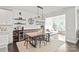 Chic dining area with modern light fixture, adjacent to a bright living space and wine storage, perfect for entertaining at 6320 Tilley Way, Matthews, NC 28105